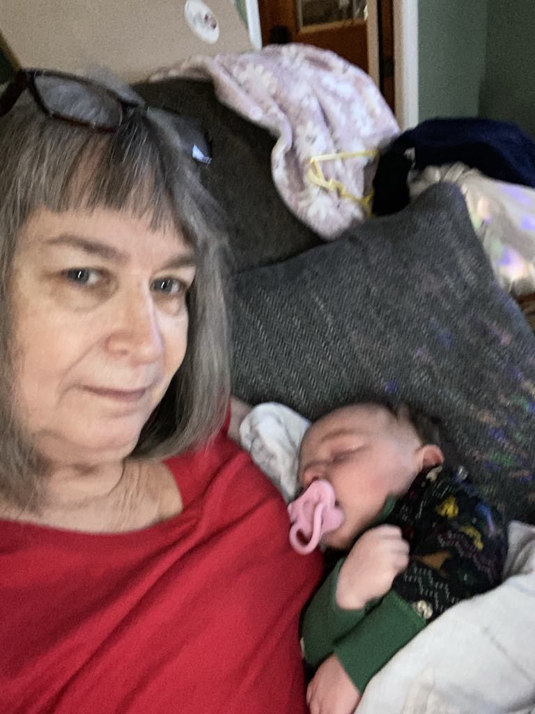Kaye Terry - Fall 2024 holding great niece. Before starting Product Regimen.